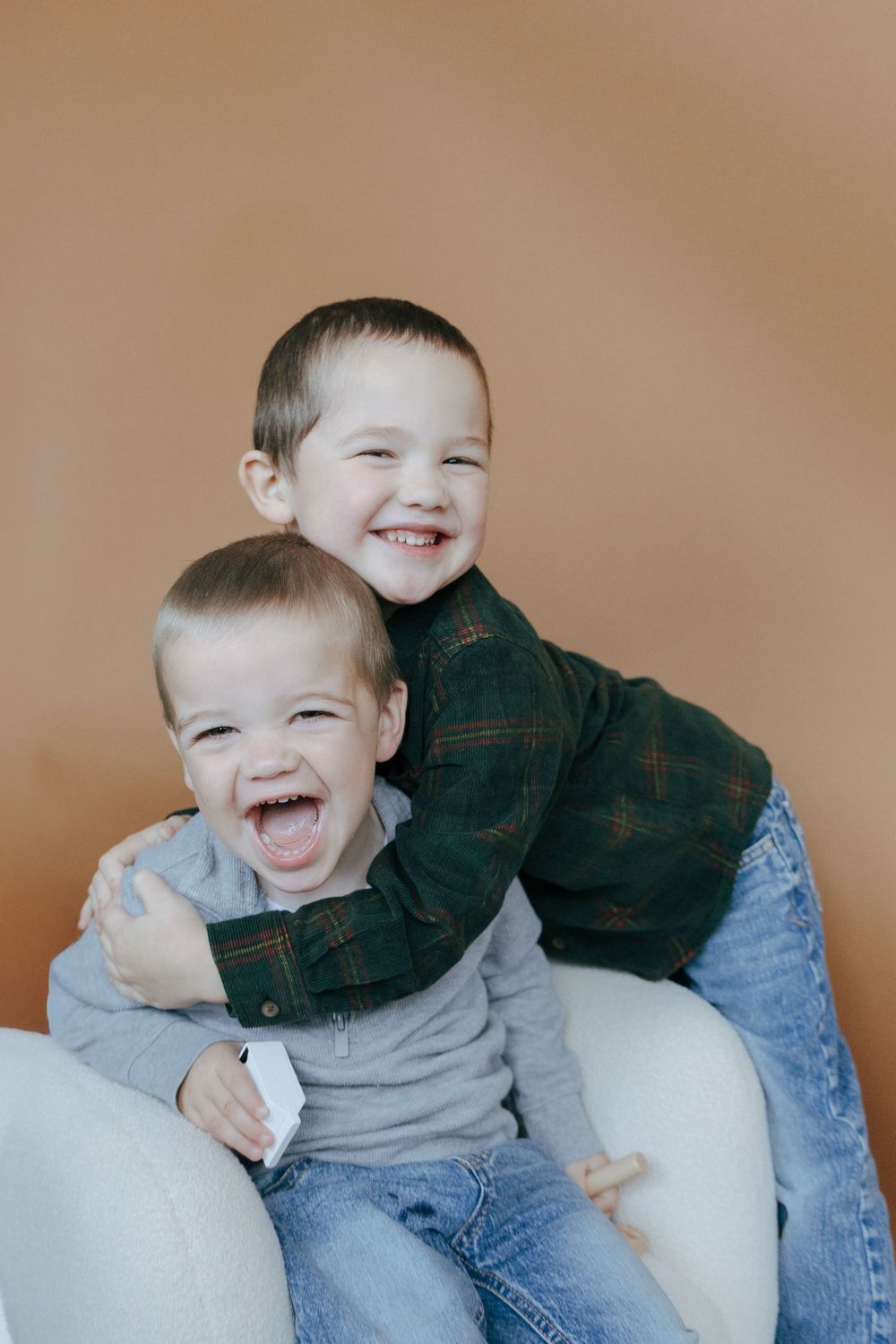A series of candid photos showing joyful expressions and laughter against a neutral beige background.