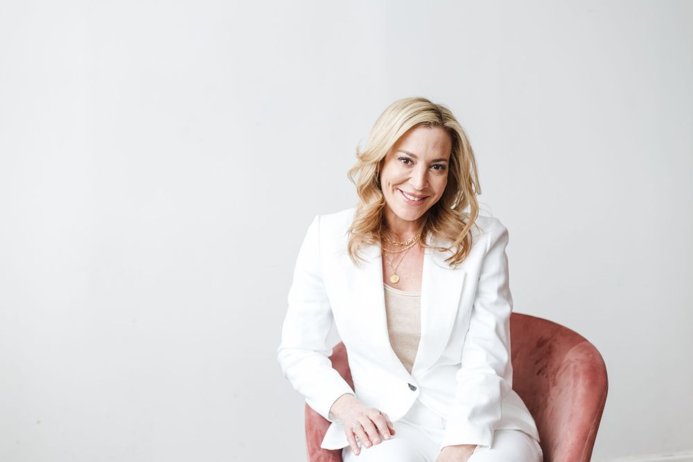 Professional wearing a crisp white blazer poses confidently against a light background in multiple shots.