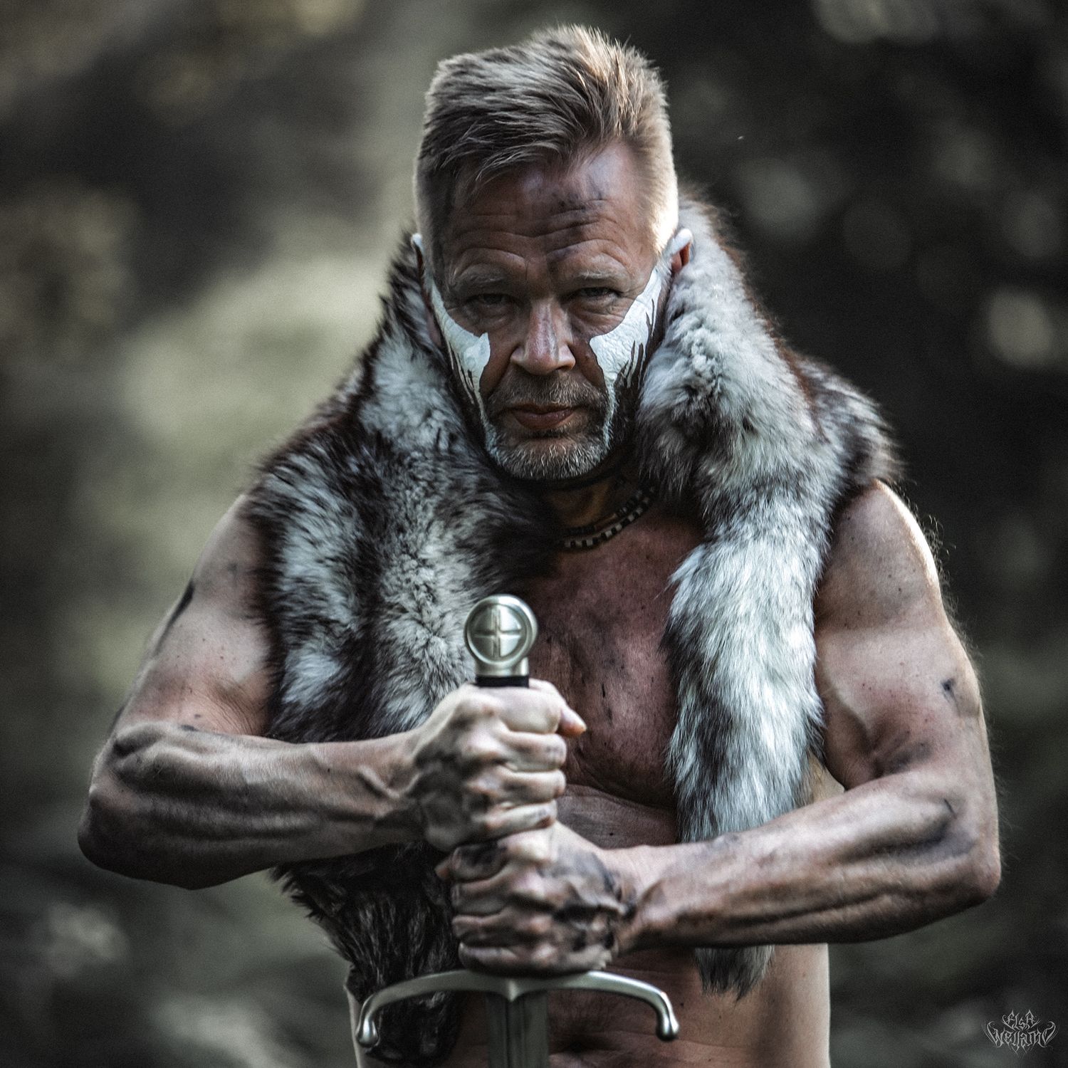 A muscular warrior in fur-trimmed vest grips a steel sword in dramatic lighting.