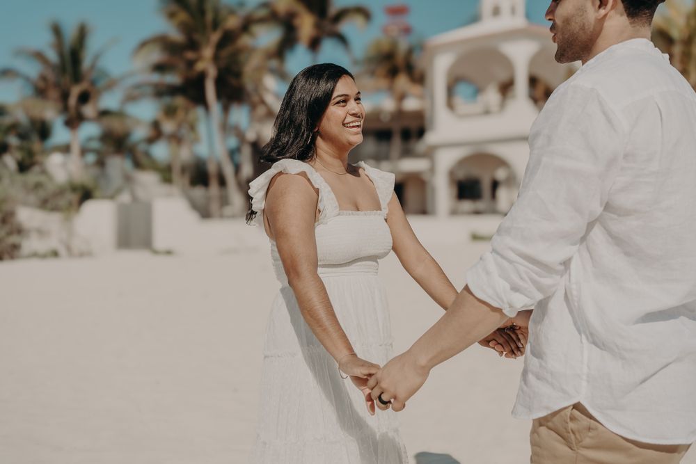 Romantic beach photoshoot with palm trees and white architecture in the background photoshoot in Puerto Morelos.