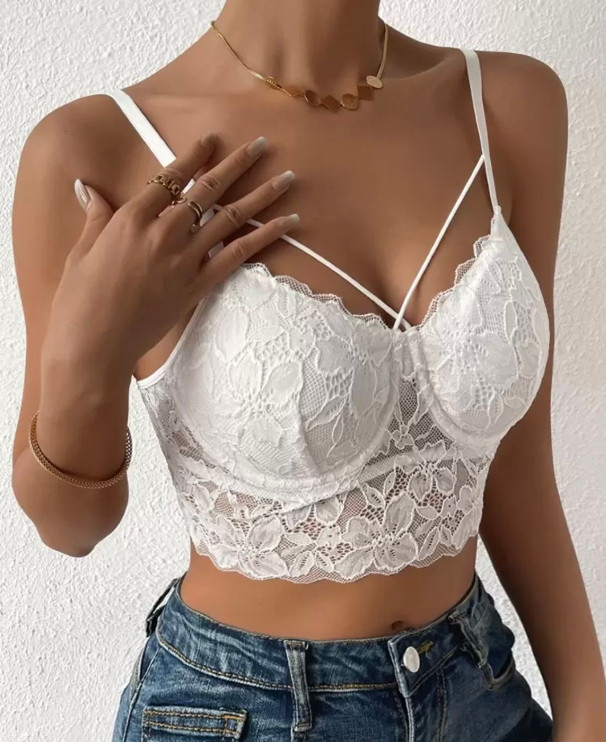A white lace bralette shown from different angles against a white background.