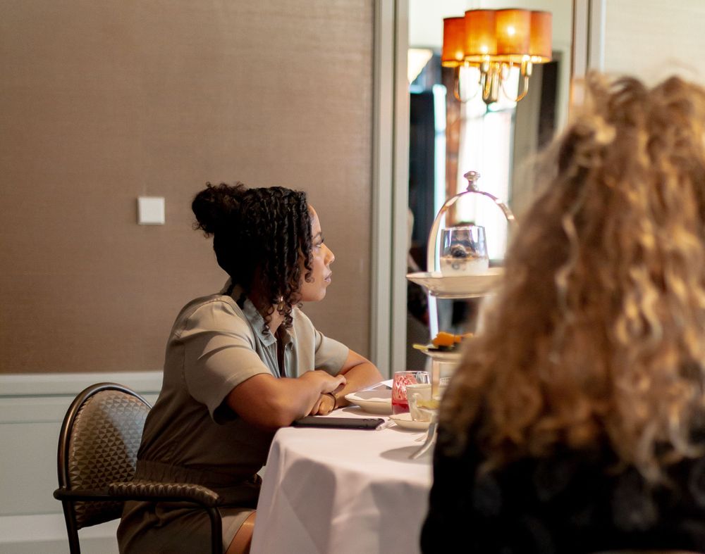 Side view of diners seated at tables in an upscale restaurant setting.