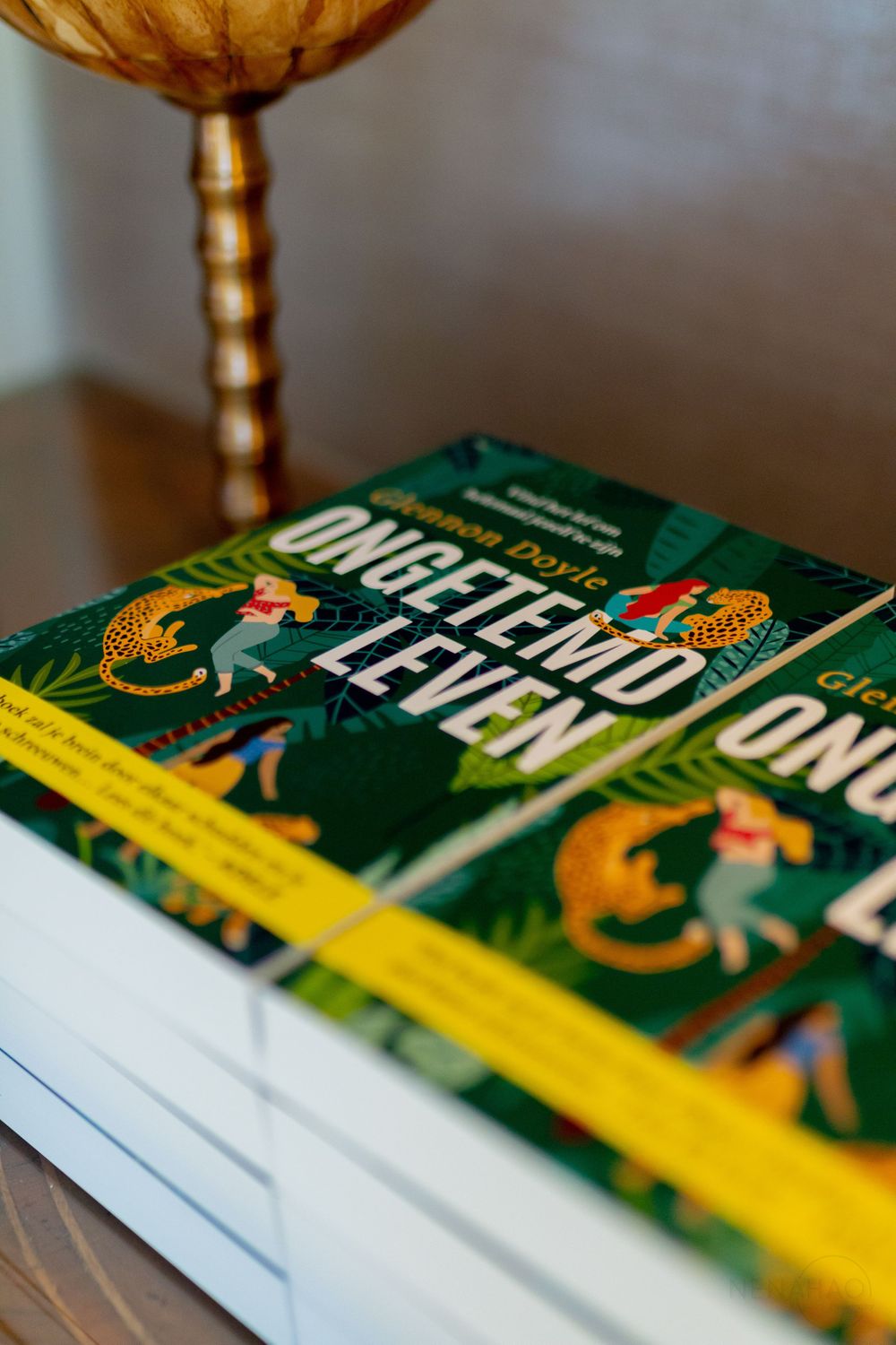 Close-up shots of green book covers with gold accents arranged in a sequence.