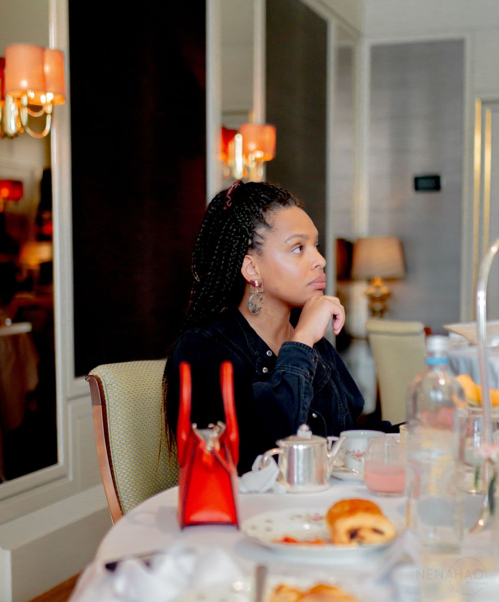 Diners seated at an elegant table with warm lighting and white tablecloths.