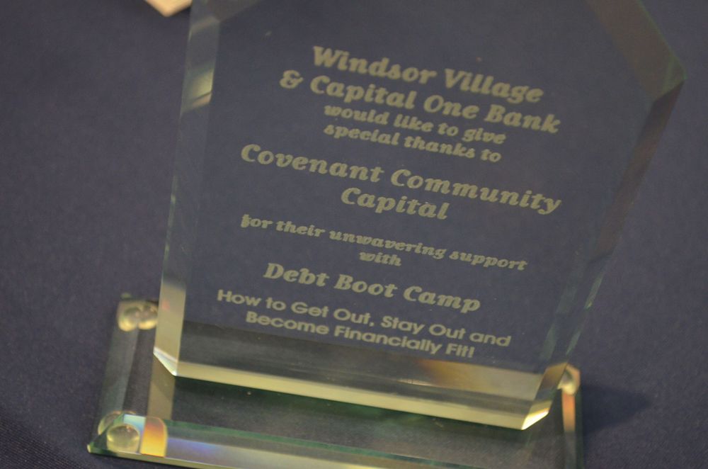 Glass award trophy recognizing Covenant Community Capital for supporting Windsor Village and Capital One Bank Debt Boot Camp program.