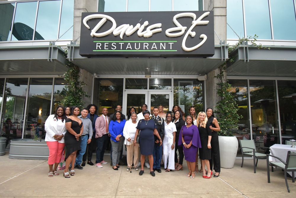 Large group gathered outside Davio's restaurant for group photo.