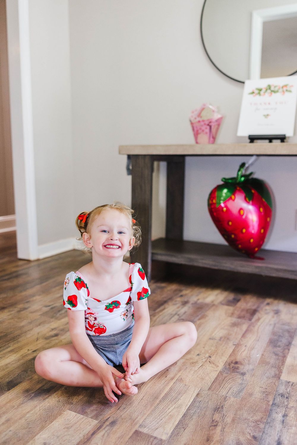 Birthday photo shoot of a strawberry themed three year old birthday shoot located in Clover, SC.