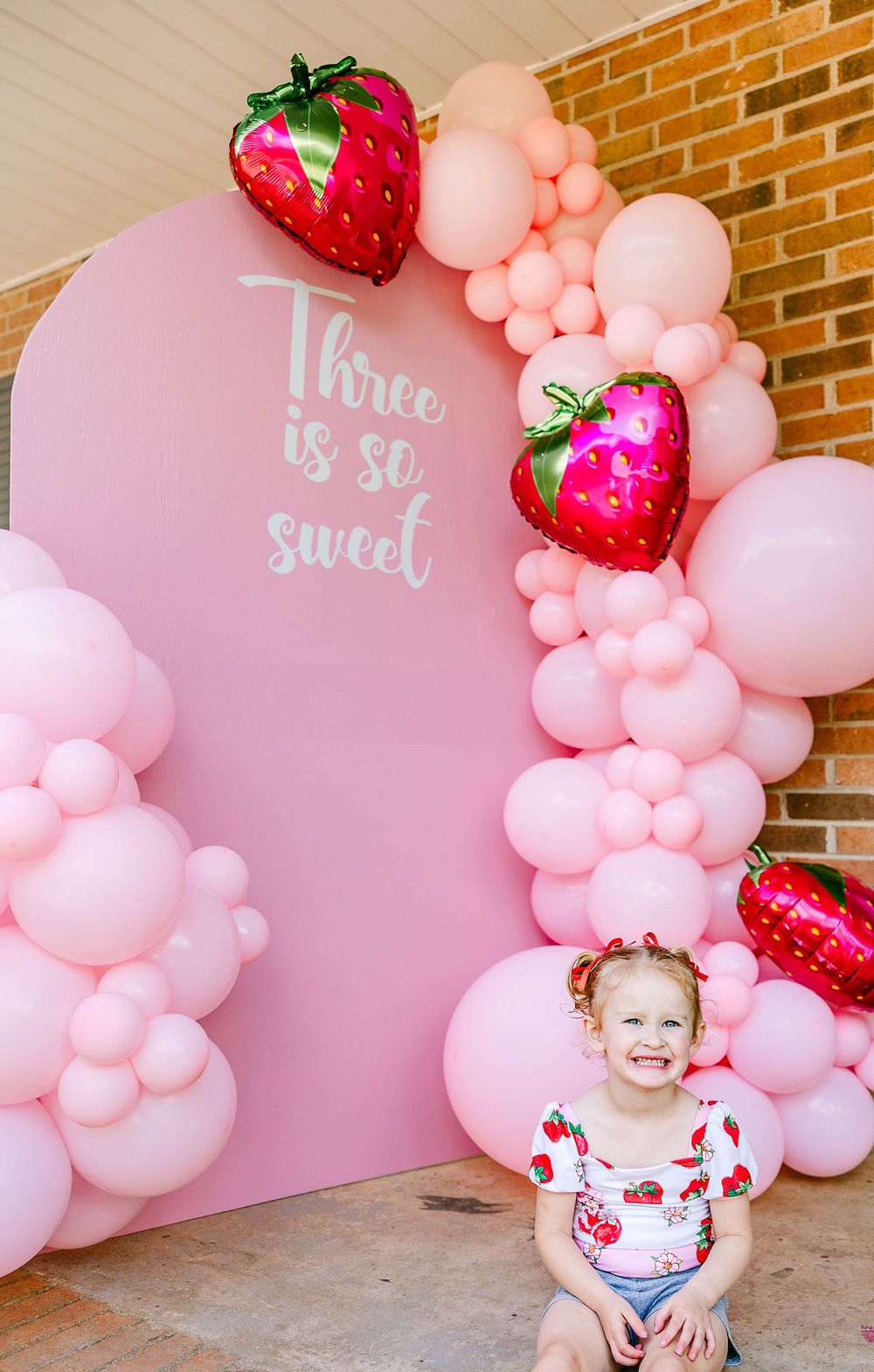 Milestone photo of a strawberry themed three year old birthday shoot located in Clover, SC.