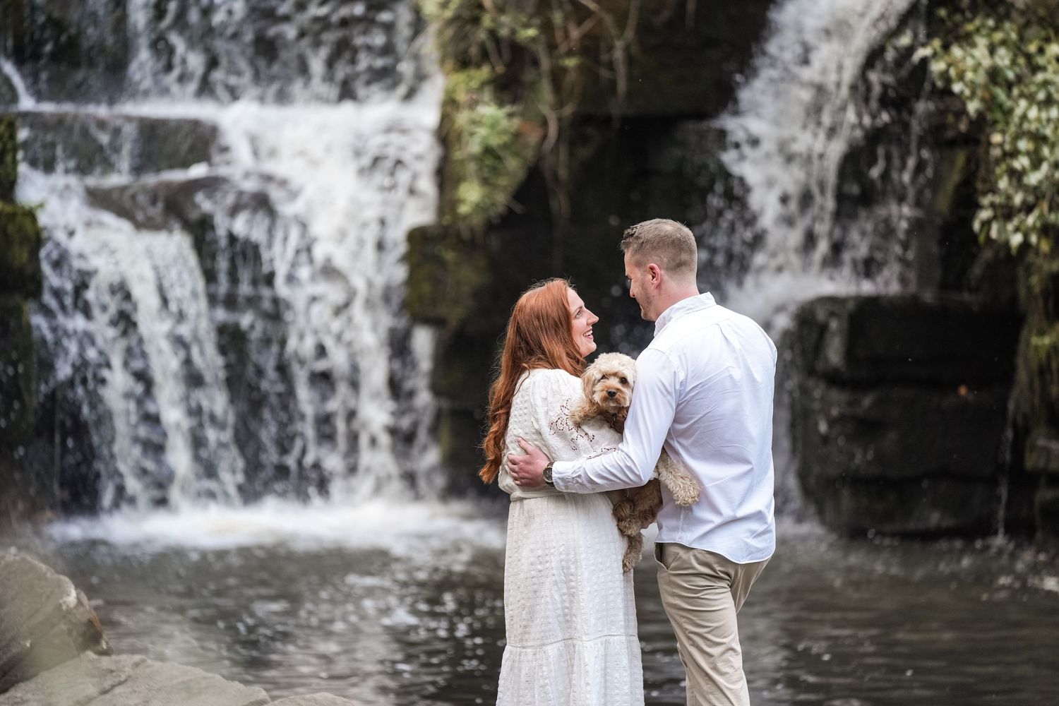 Romantic photoshoot by a cascading waterfall in nature.