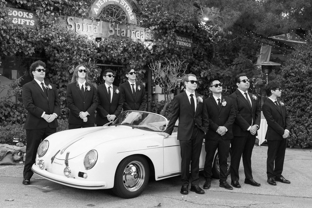 Groomsmen look into the distance and pose in black and white