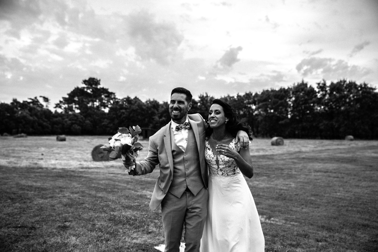 A candid wedding celebration moment captured in black and white photography.