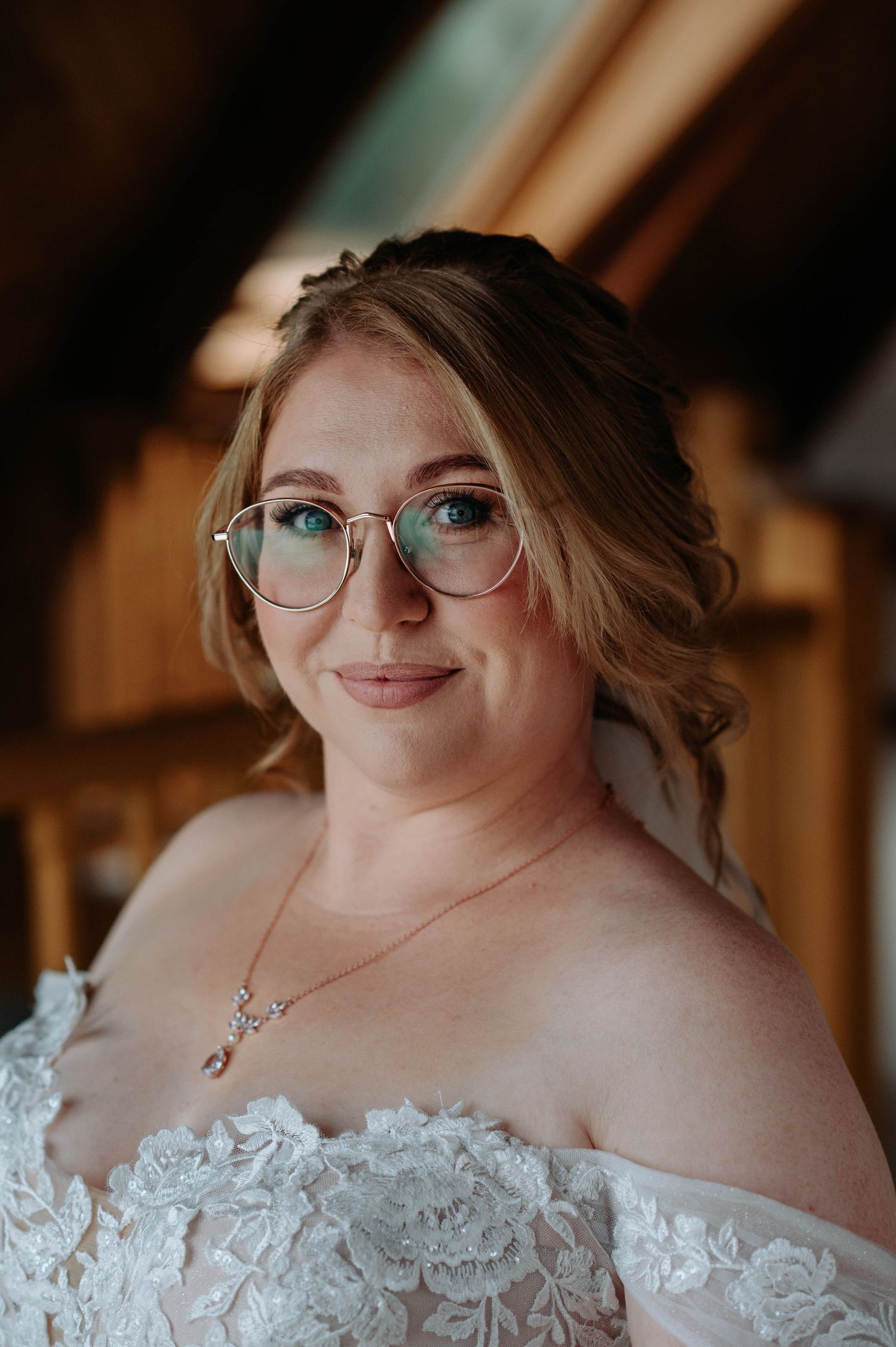 An elegant bridal portrait in a rustic attic setting with natural lighting.