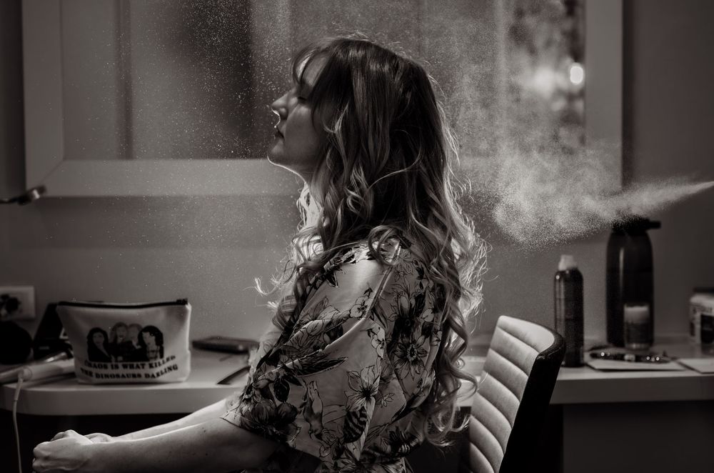 Artistic black and white portrait showing vapor trails in moody lighting.