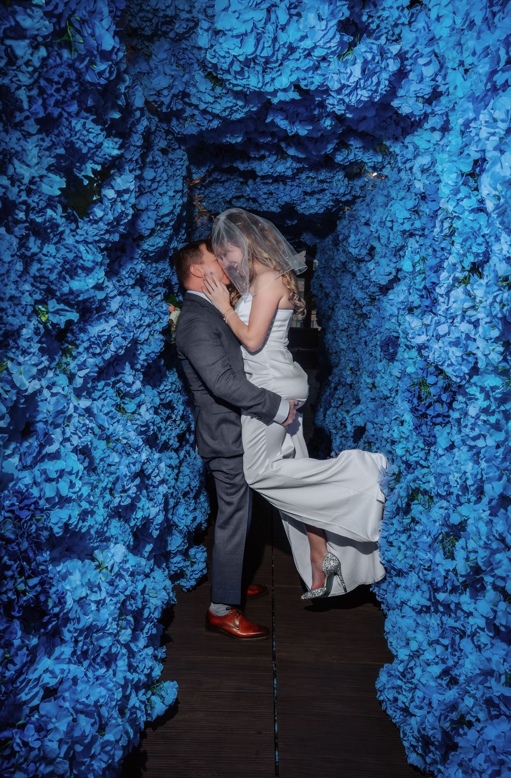 A dramatic dip pose against a backdrop of ethereal blue lighting and textures.