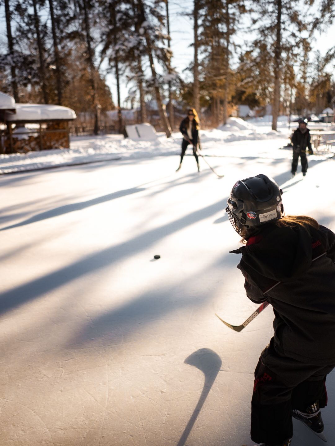 Winter ice skating sequence showing movement across a snowy outdoor rink.