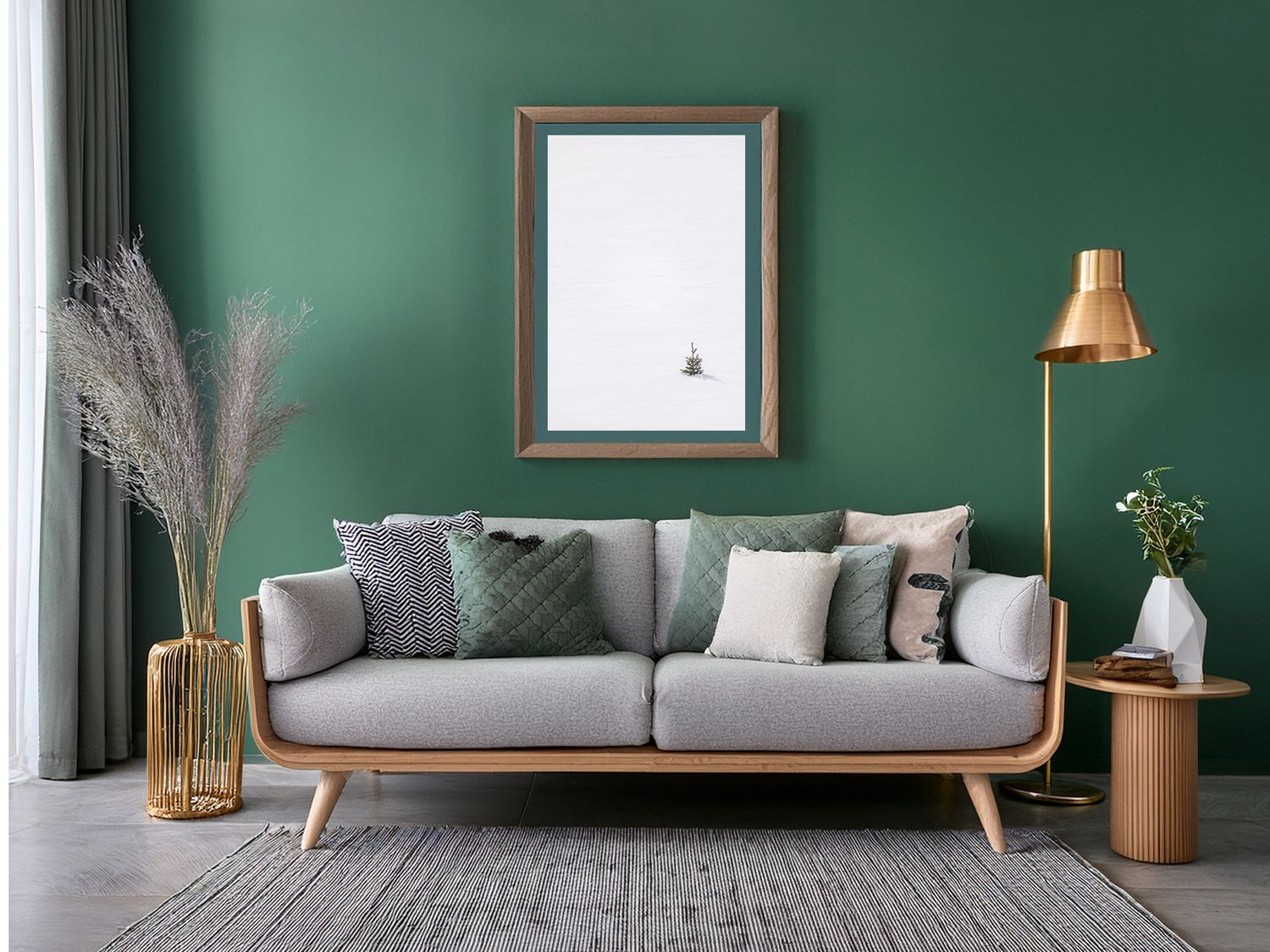 Elegant living room with gray sofa, wooden accents, and minimalist decor against a deep green wall.