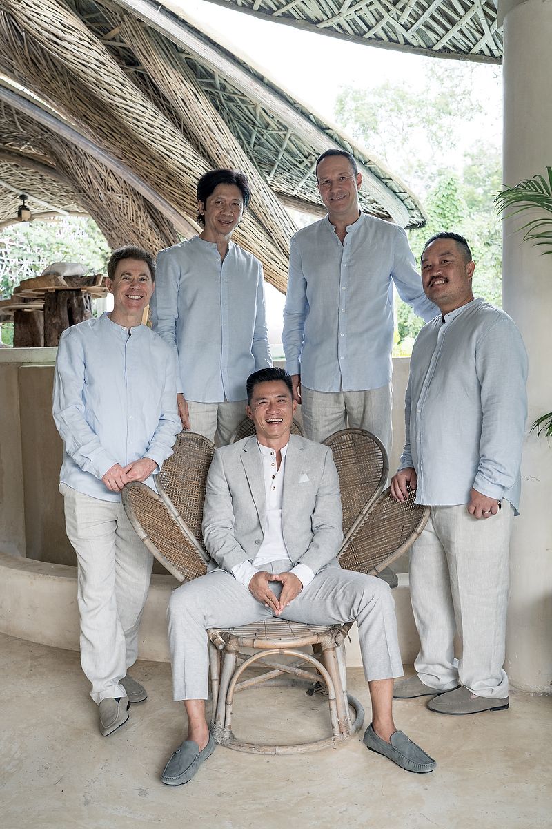 Groom and groomsmen posing together in a modern jungle-inspired space at KAN Tulum during a luxury destination wedding.