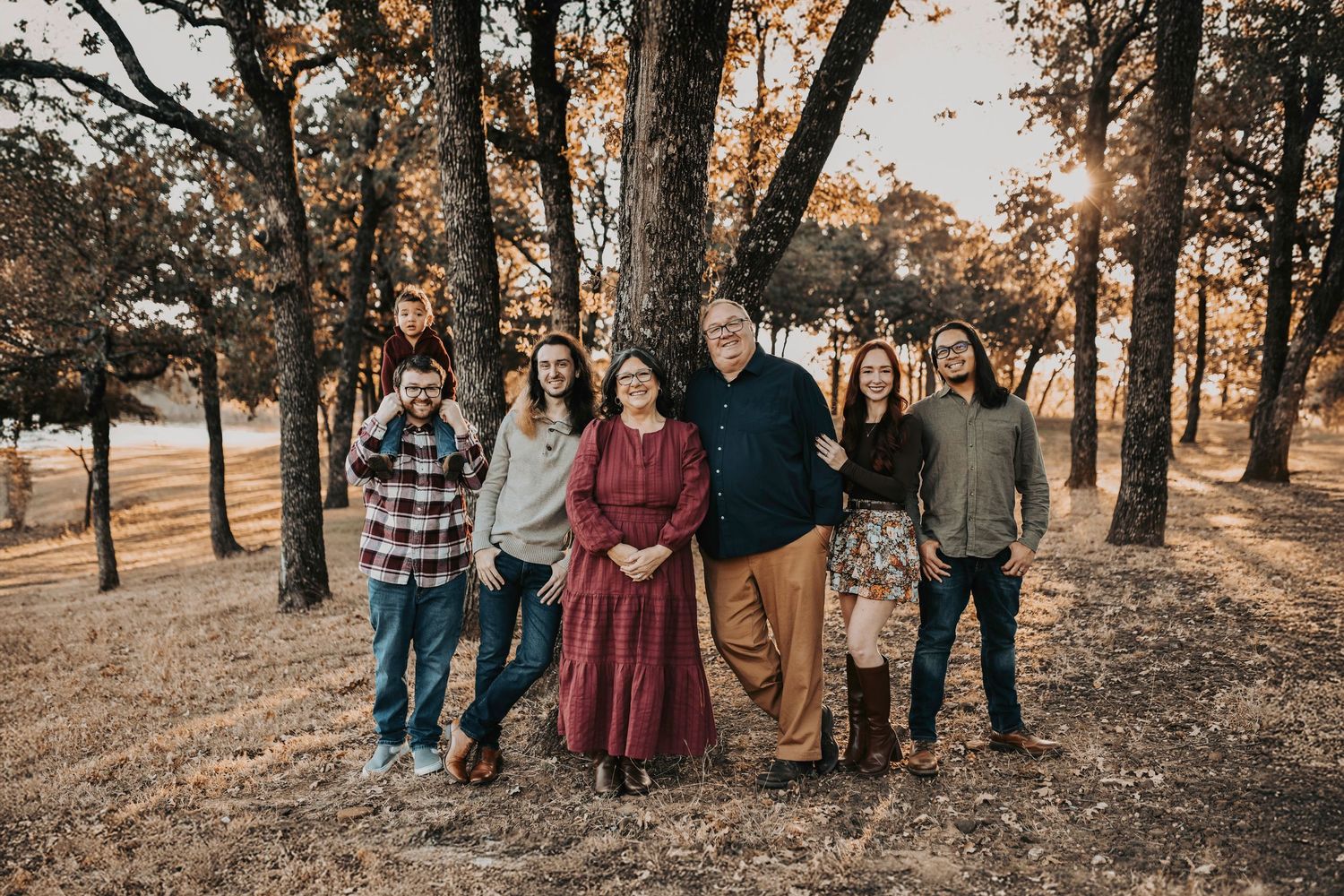 Cozy extended family group portrait in knit layers and fall textures by the lake.