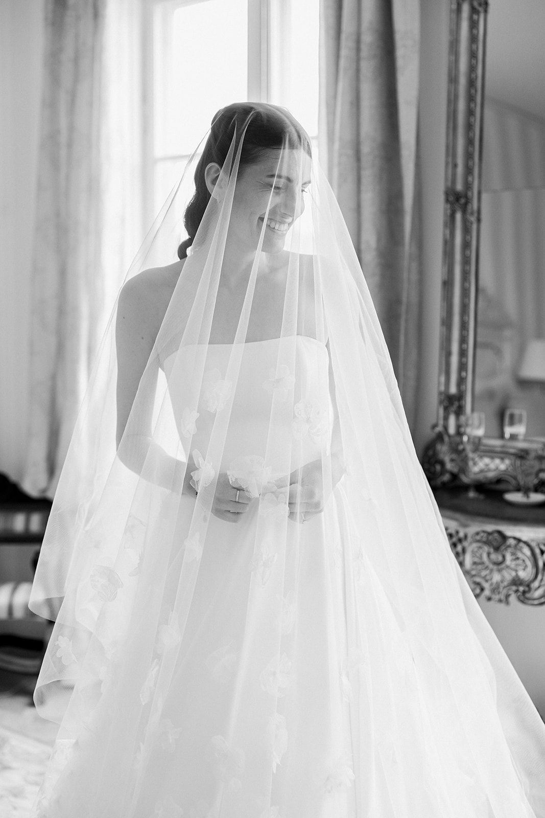 A series of elegant bridal portraits showing a white veil flowing gracefully in different poses against a light interior backdrop.