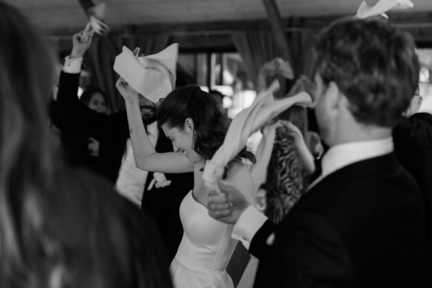 Black and white photos show people dancing and celebrating at a wedding reception.