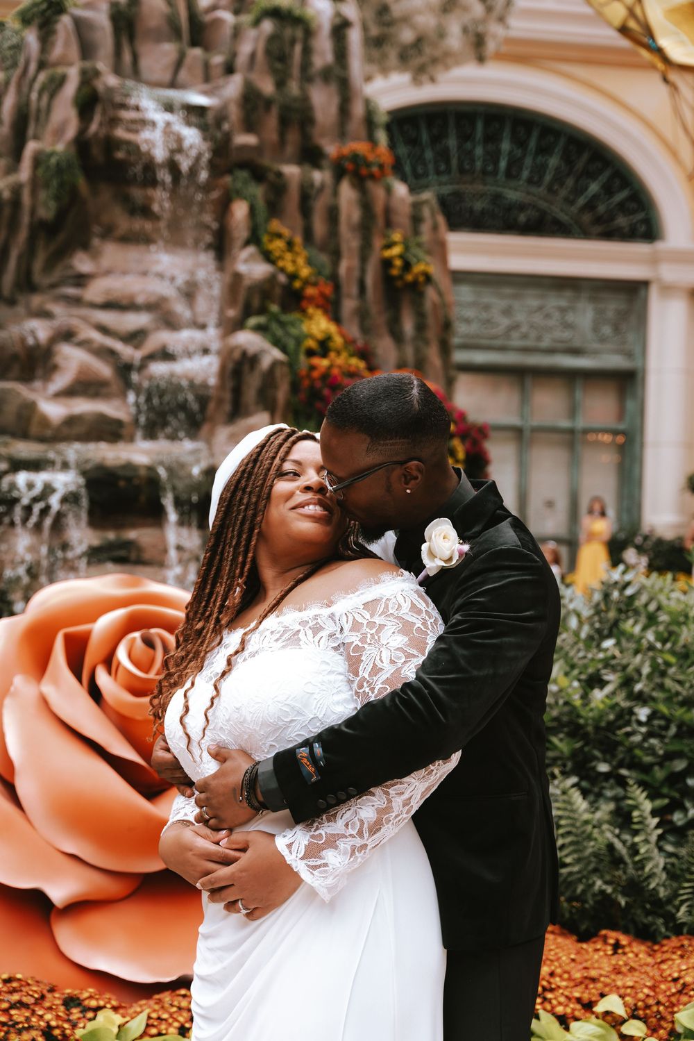 A romantic wedding photo sequence showing tender moments between a couple in white dress and black suit near peach roses.