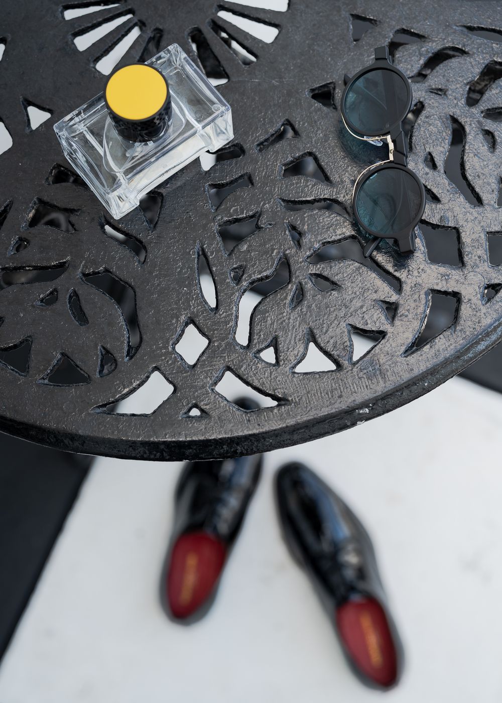Close-up sequence of a black circular metal grate or decorative pattern with geometric cutouts and shadows.