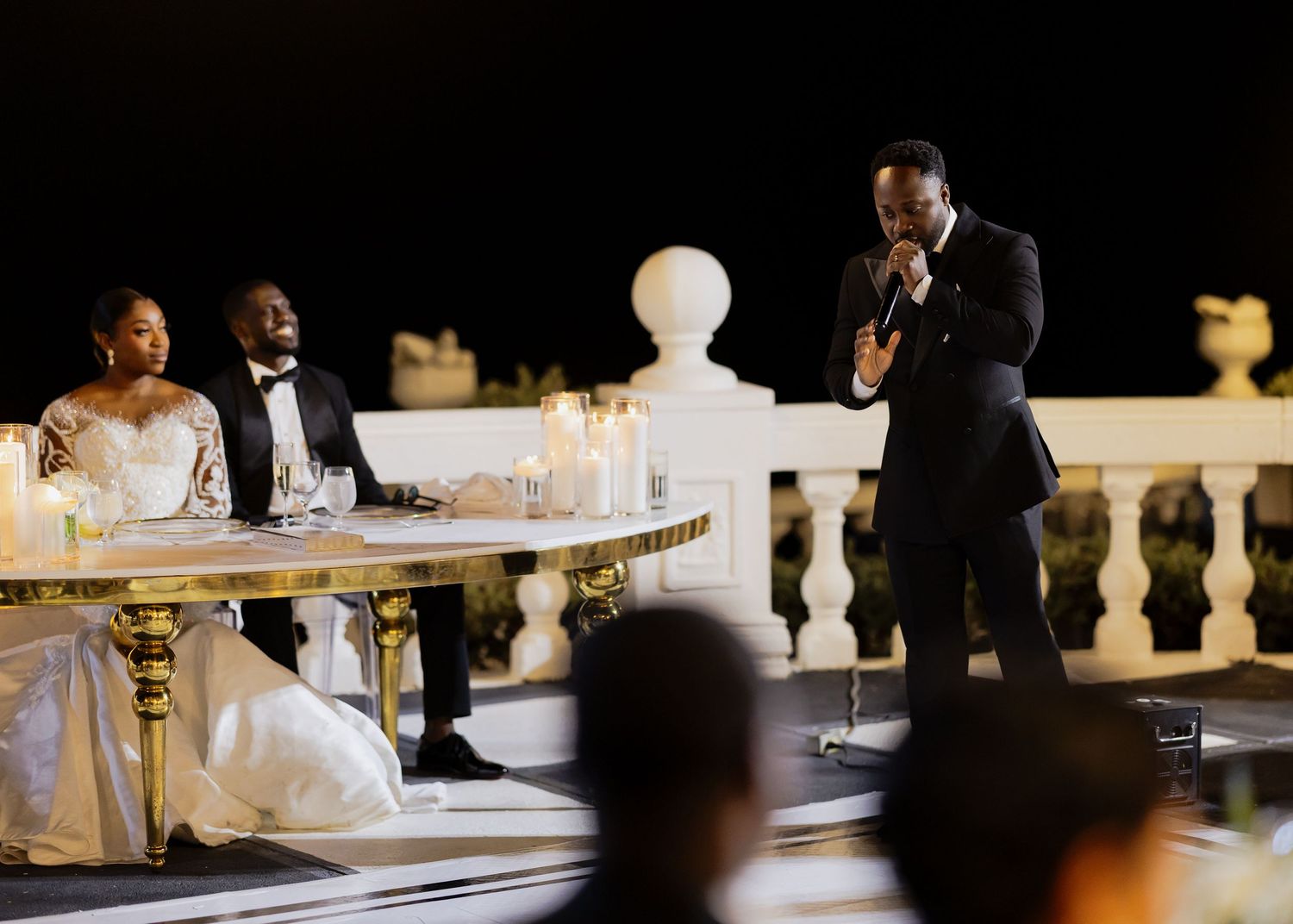 Newlyweds share their first dance under sparkling chandeliers and romantic lighting.