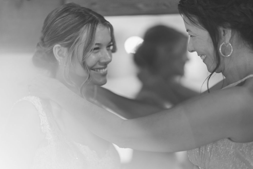 Black and white wedding photos arranged in a horizontal row showing intimate moments between the couple.