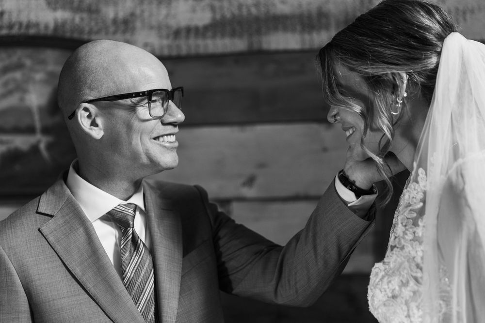 A series of black and white wedding photos showing joyful moments between a couple during their celebration.