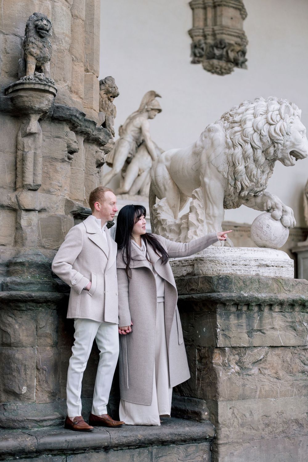 A romantic black and white photo series of a couple in light colored outfits sitting by a waterfront Florence Tuscany couples photographer.