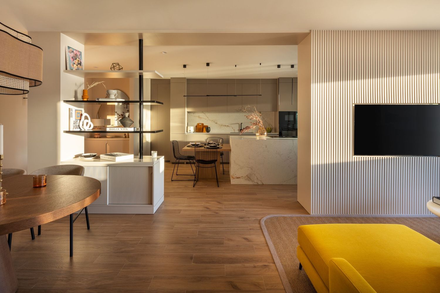 Modern minimalist dining area with white table, chairs, and sideboard in a bright room with natural decor elements.