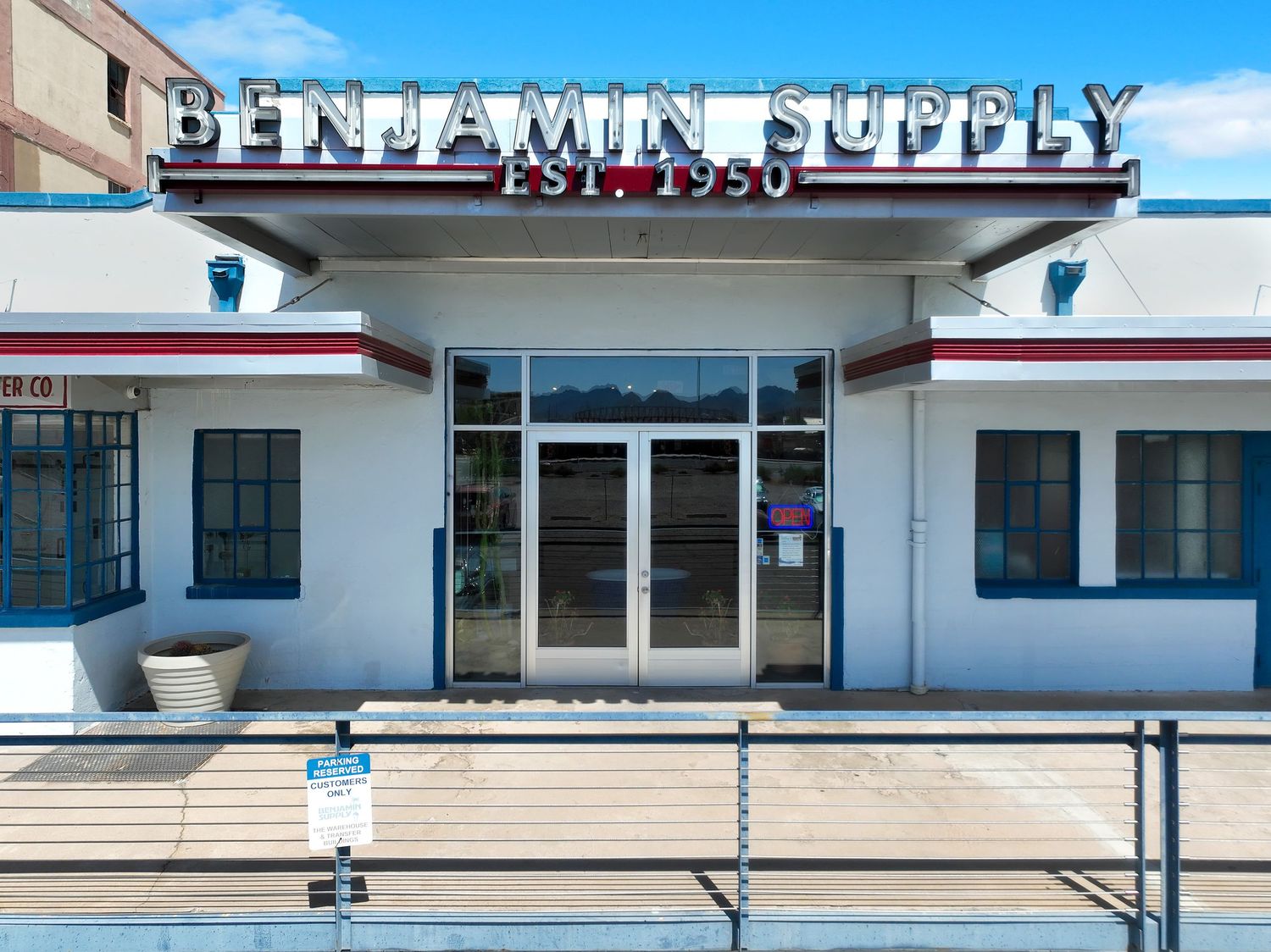 Vintage-style storefront with Benjamin Supply signage and classic architectural details.