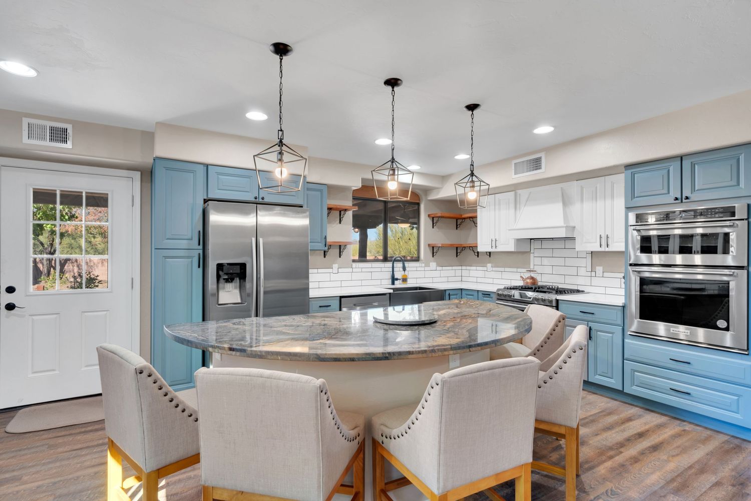 Contemporary kitchen featuring turquoise cabinets, quartz countertops, and wood accents.