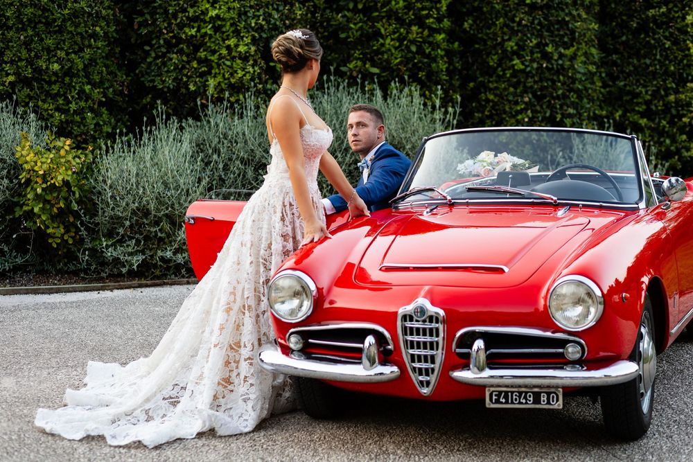 Red Alfa Romeo vintage car creating iconic Italian romance during the vow renewal.