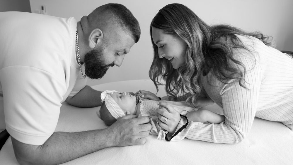 Mum and Dad playing with baby, interacting during in home session. black and white timeless classic.