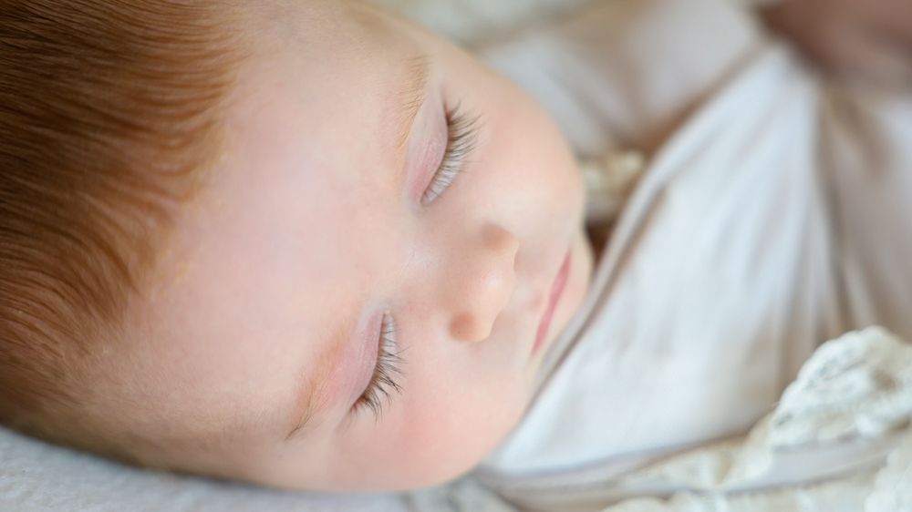 Details of baby girls long eye lashes captured whilst she sleeps during in home session.