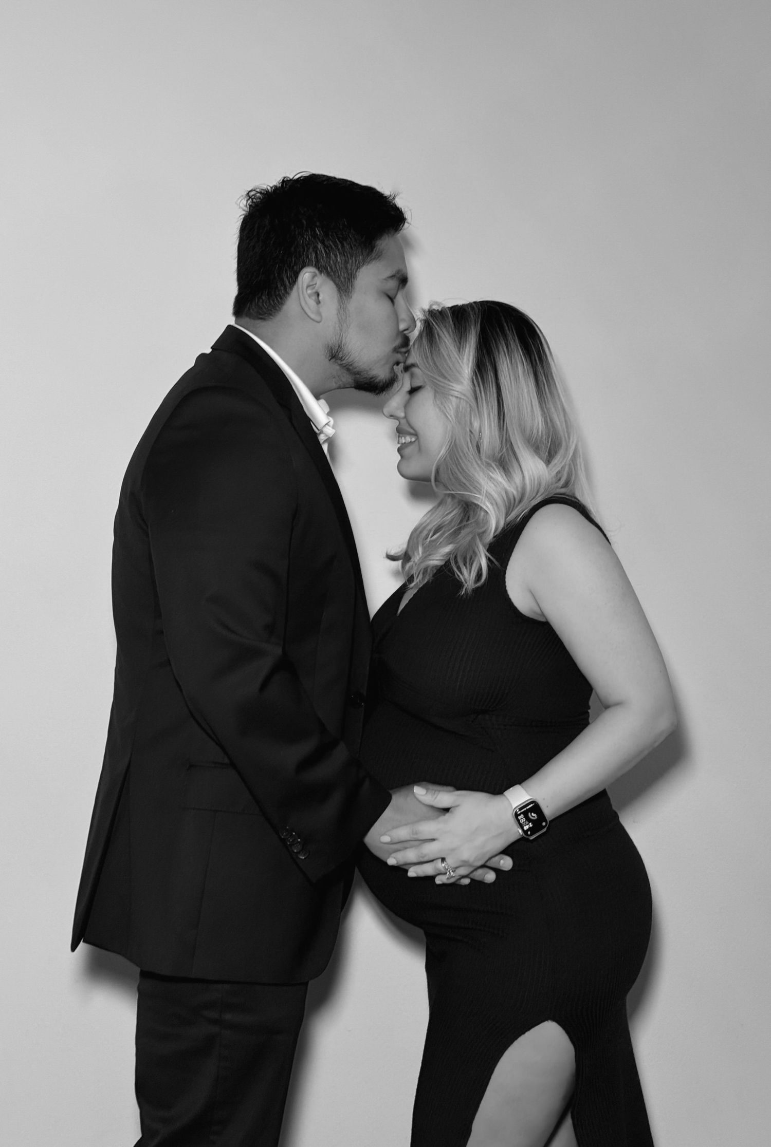 A romantic black and white photo sequence showing a couple in formal attire embracing and kissing.