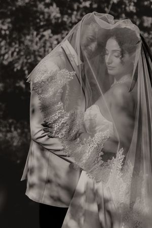 Artistic black and white series showing a bride's profile through a sheer wedding veil.