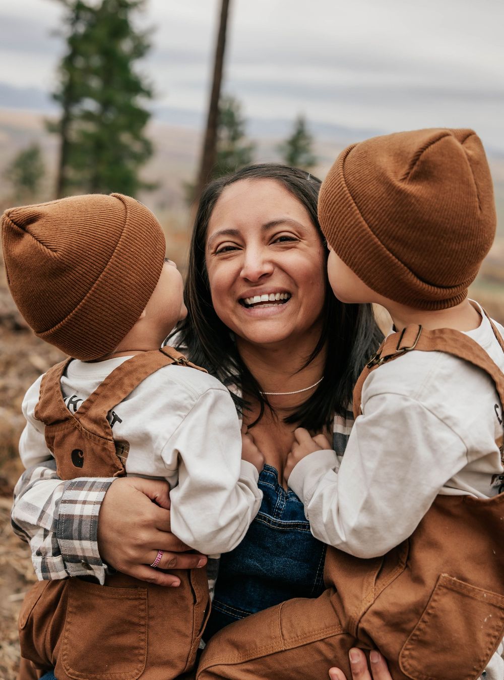 Family shares intimate candid moments together wearing coordinated brown outfits.