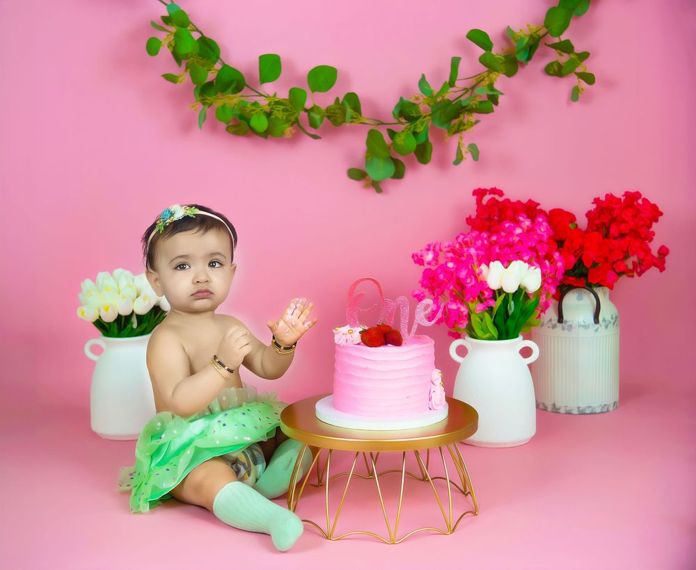Cake smash photography in Frisco + ALL of Dallas TX , by Bhaire Photography, baby celebrating first birthday with pastel cake setup.