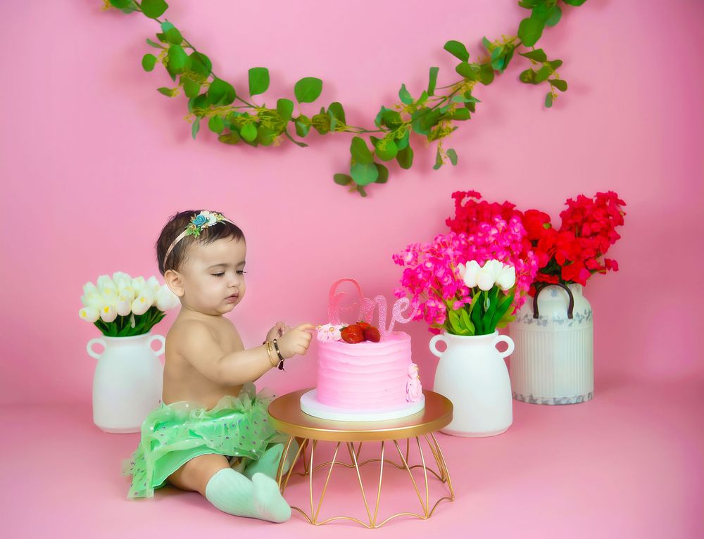 Frisco + All of Dallas Fortworth TX cake smash photography by Bhaire Photography, colorful studio setup with safe baby props.