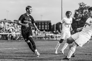 A sequence of black and white soccer action photos showing players making diving saves and tackles during a match.