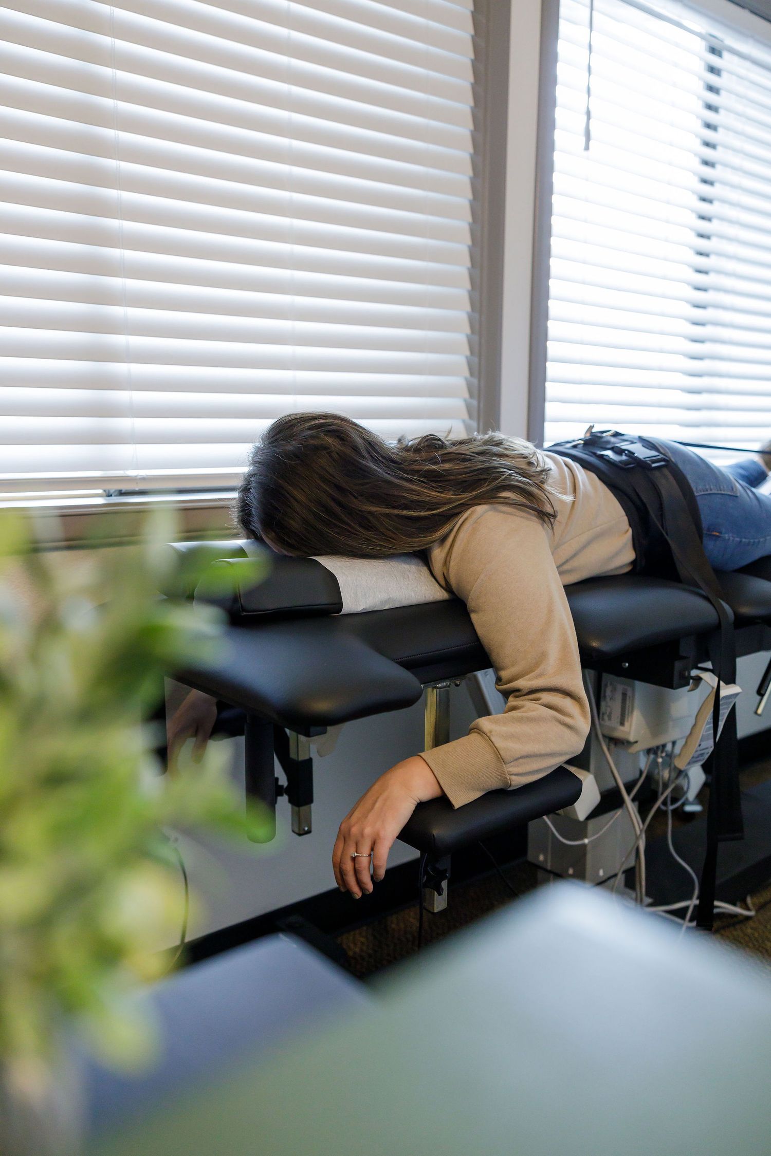 chiropractor branding photo in Sumner, WA wellness health woman laying face down on traction adjustment table for treatment