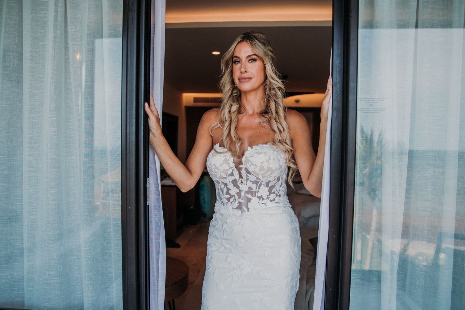 Interior of elegant bridal preparation room with sheer curtains and natural lighting. Dreams Sapphire Riviera Maya Wedding Photography