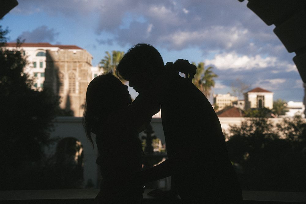 Editorial couple portrait framed by soft light and grand architecture in Pasadena City Hall.