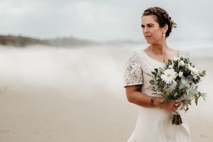 A bridal photoshoot series on a serene beach with coastal scenery and white floral bouquet.