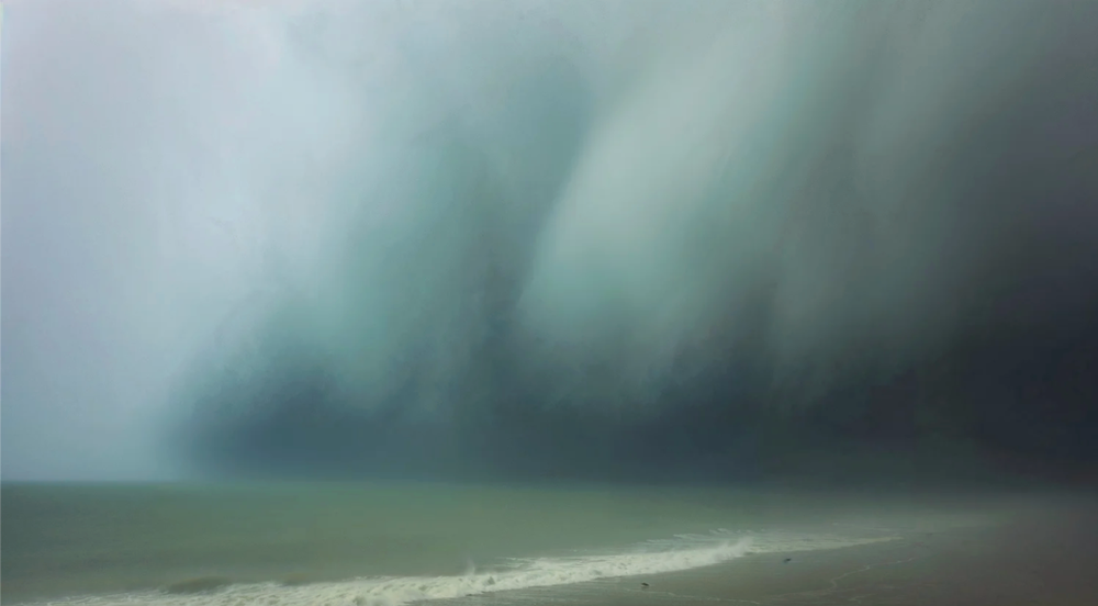 Ethereal coastal scene with soft turquoise storm clouds rolling over the ocean.