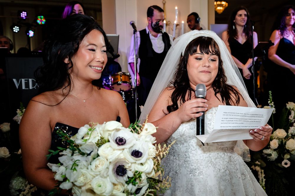 Wedding reception celebration with floral arrangements and festive lighting.