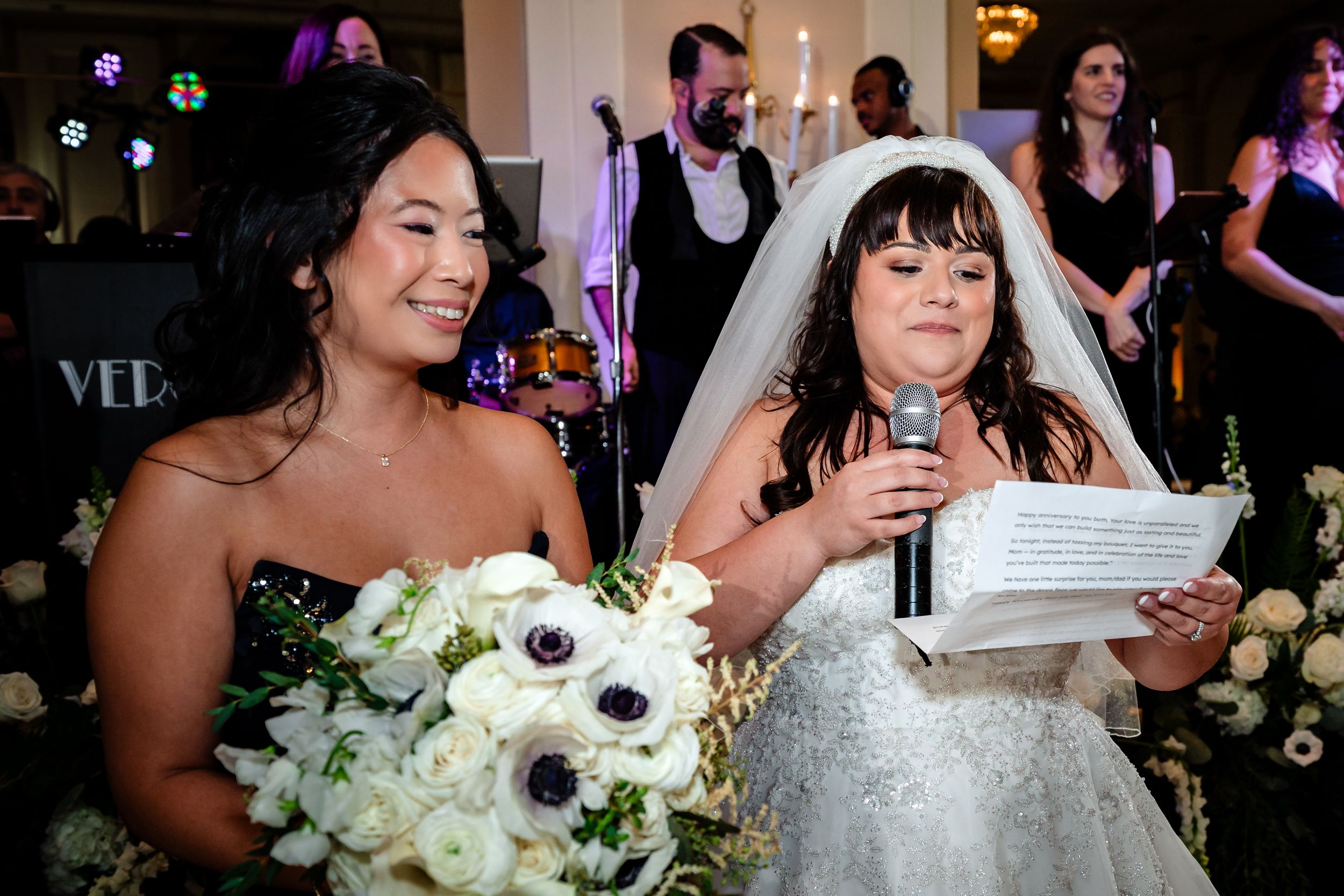 Wedding reception celebration with floral arrangements and festive lighting.