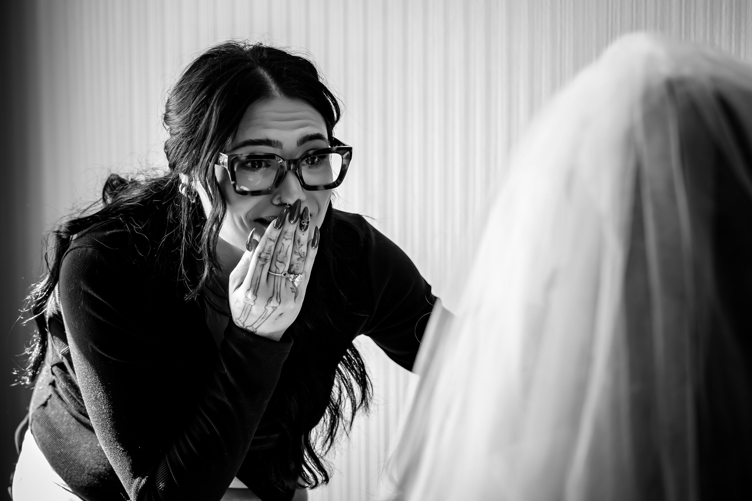 Black and white wedding preparation scenes with bride and attendants.